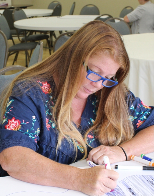 Woman in glasses writing down her thoughts